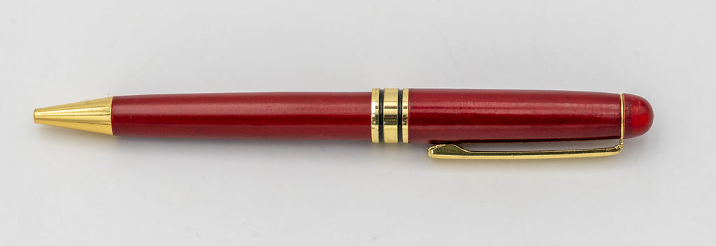 Bolígrafo de madera de acabado rojizo sin tapa, con clip y punta dorados.