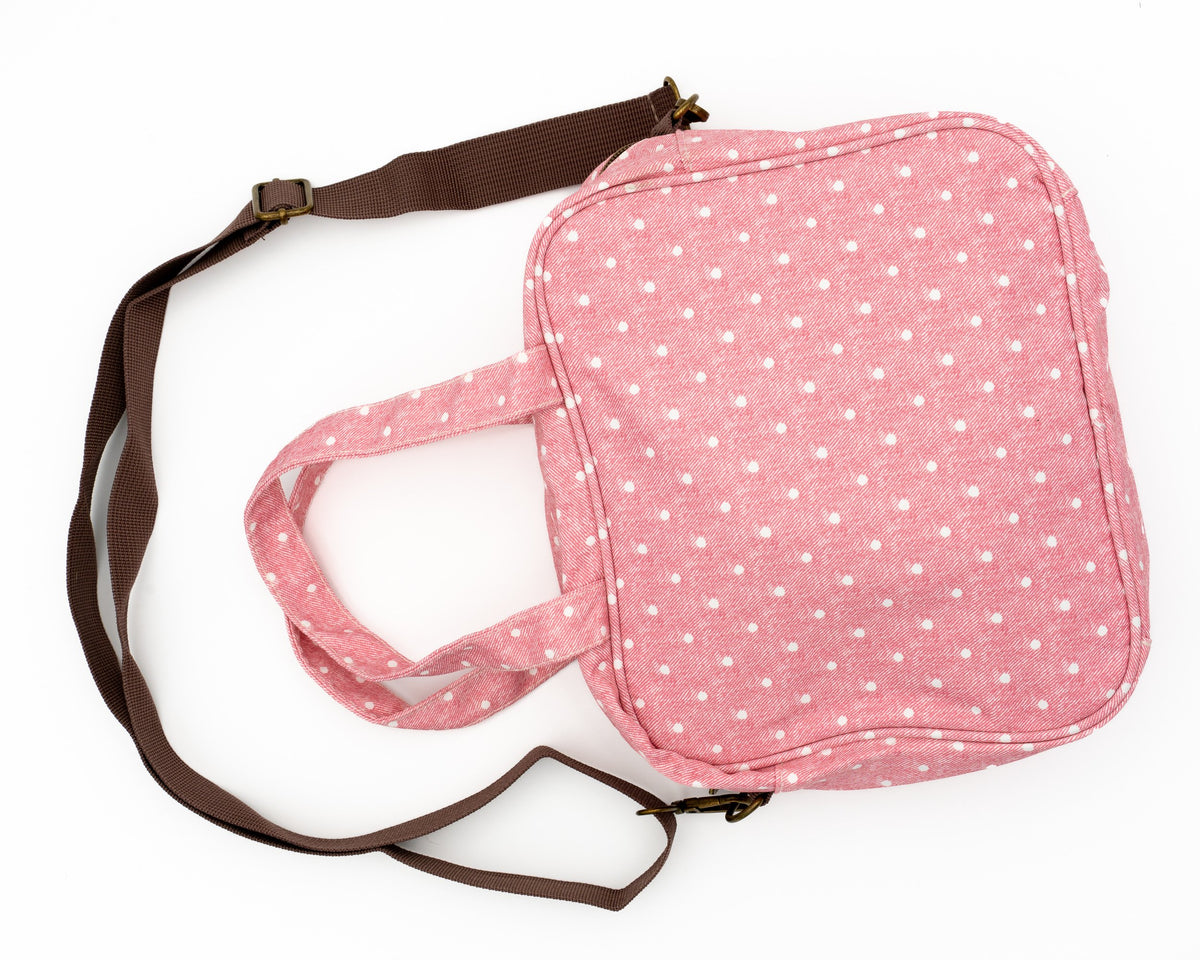 Bossa de canvi rosa de lunars amb bandolera