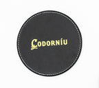 Posavasos redondo negro con logotipo Codorníu en ton dourado.