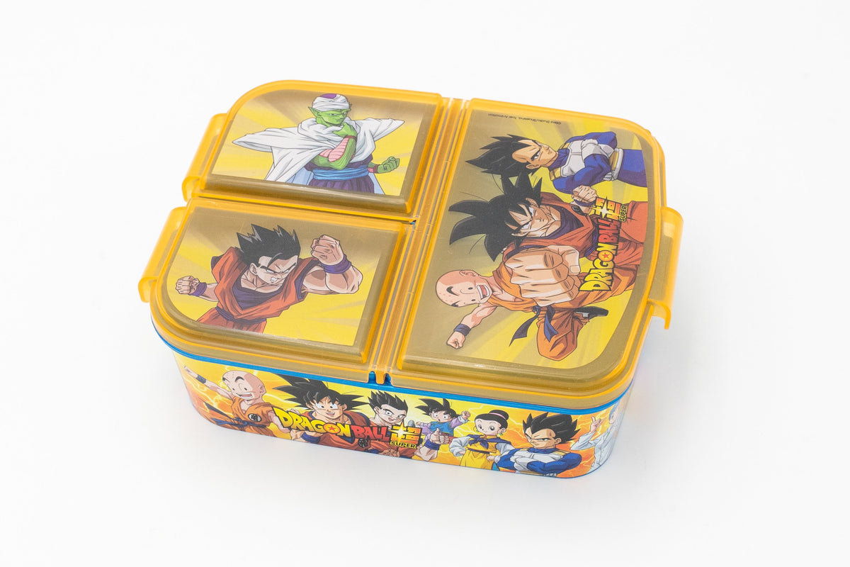 Dragon Ball Super eskola-janari-kutxa horia, hiru konpartimentu eta tapetan animeko pertsonaiak dituena