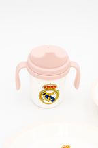 Vaso de aprendizaje rosa con dos asas y boquilla antiderrames del Real Madrid para niños.