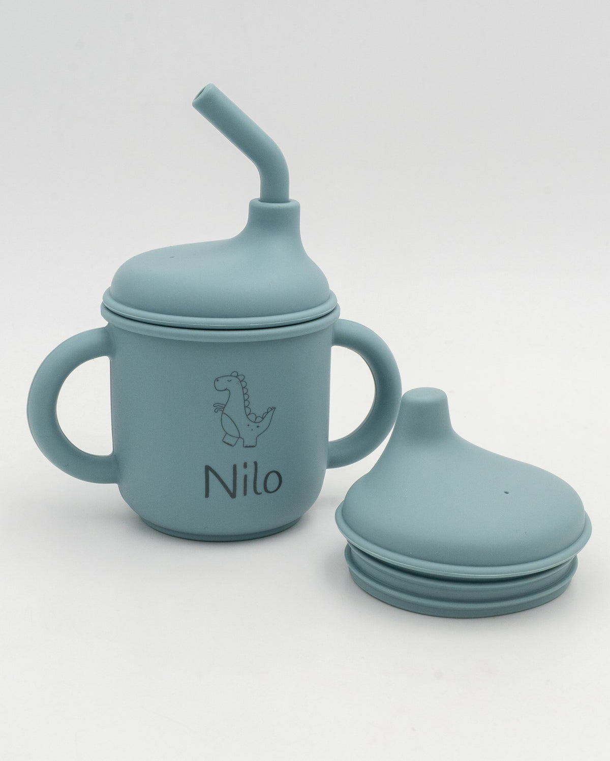 Vaso 3 en 1 azul acinzentado co nome Nilo e un dinosauro gravados, xunto á tapa de succión