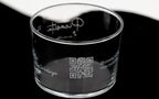 Vaso de cristal personalizado con código QR y nombres de invitados grabados para eventos sociales.