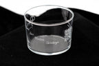 Vaso de cristal transparente con nombres grabados en cursiva sobre una superficie oscura elegante.